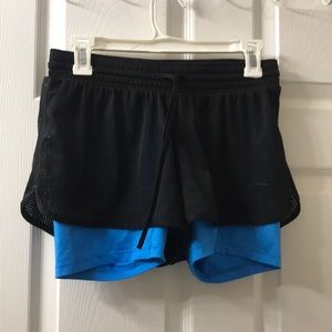 Black net shorts with blue spandex underneath